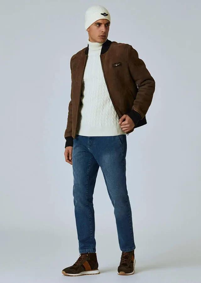 man in white sweater and jeans