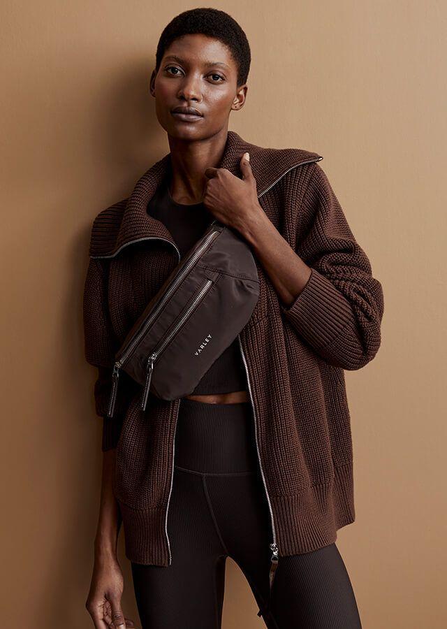 Standing woman in brown jacket styled in the 1970s