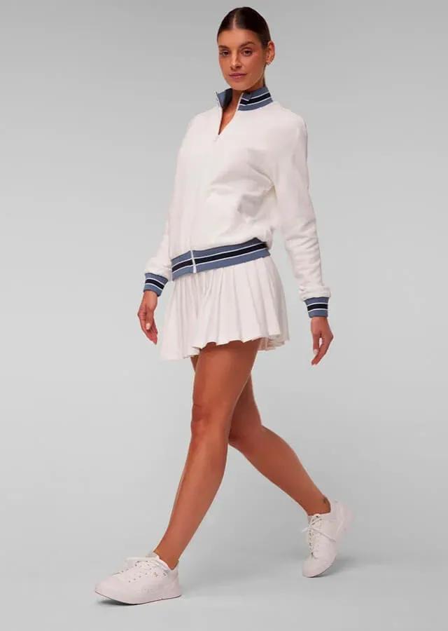 Woman wearing a tennis outfit consisting of a tennis skirt