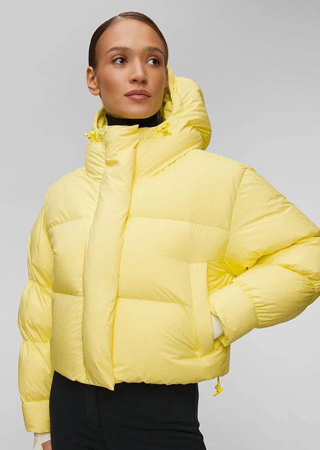  Kobieta w puchowej kurtce w odcieniu butter yellow. 