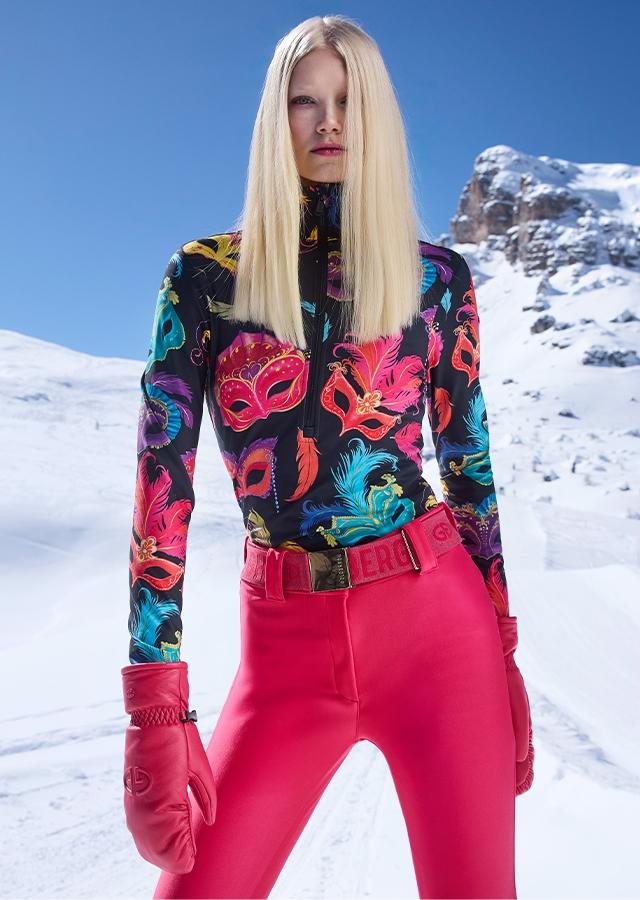 Kobieta na stoku w różowych spodniach narciarskich Kobieta na stoku w różowych spodniach narciarskich